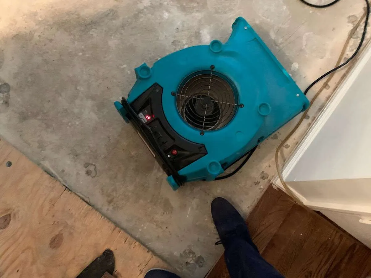 Air mover drying subfloor during Commercial Water Damage Restoration in Cape Coral
